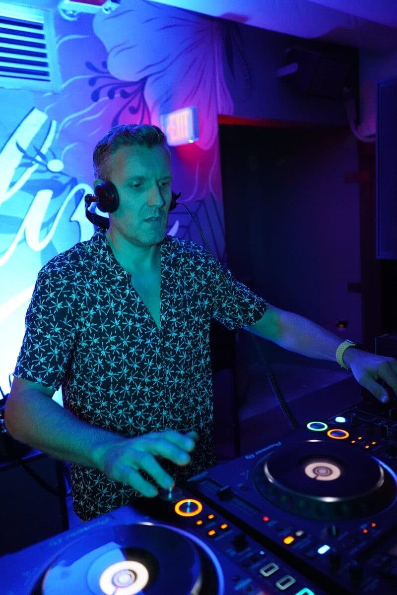 Dan DJing with headphones at Essential