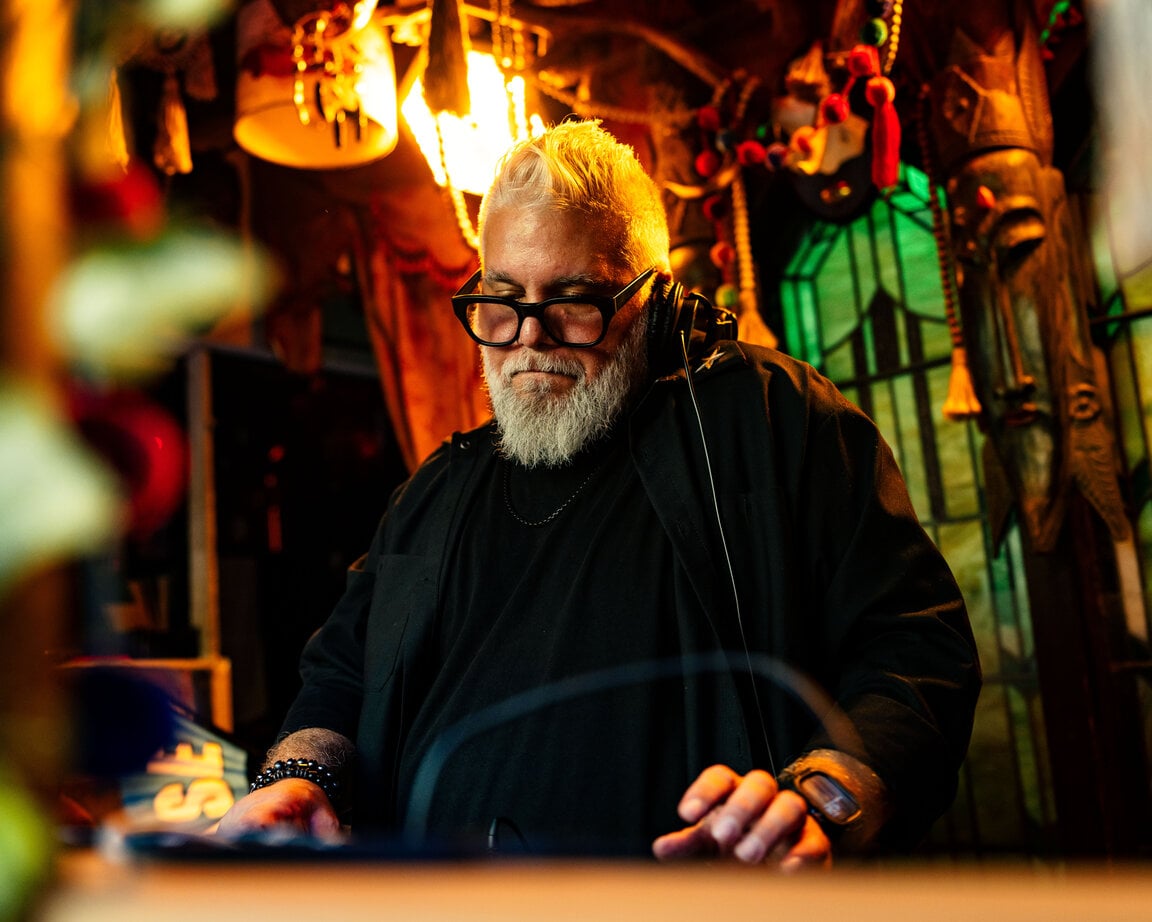 DJ set bathed in warm light at BOHO House