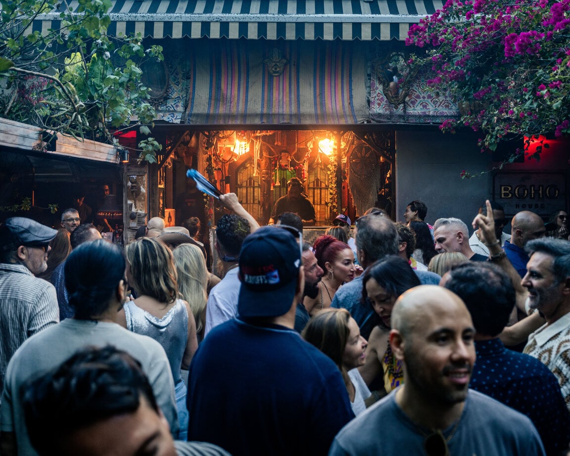 Packed crowd under the bougainvillea